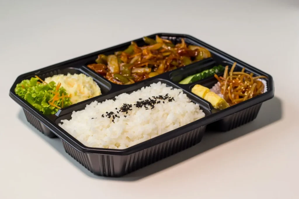 Dua makna 'tebentō': sebuah kotak bekal buatan tangan dan seseorang yang bekerja secara sukarela.