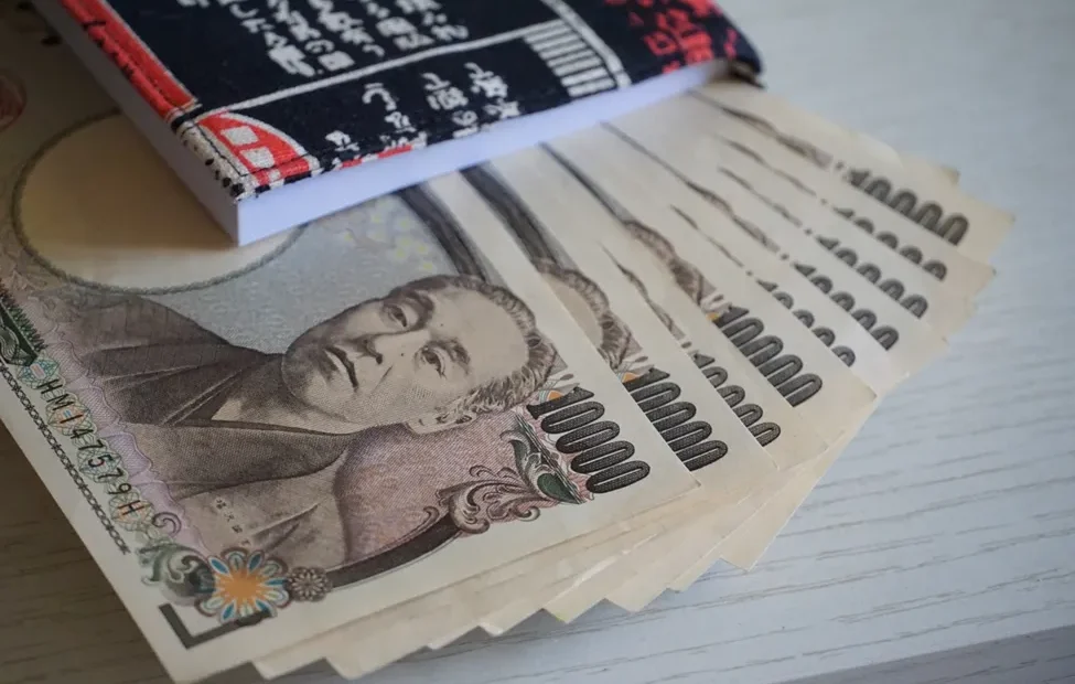 Tumpukan uang kertas Yen Jepang dan koin.