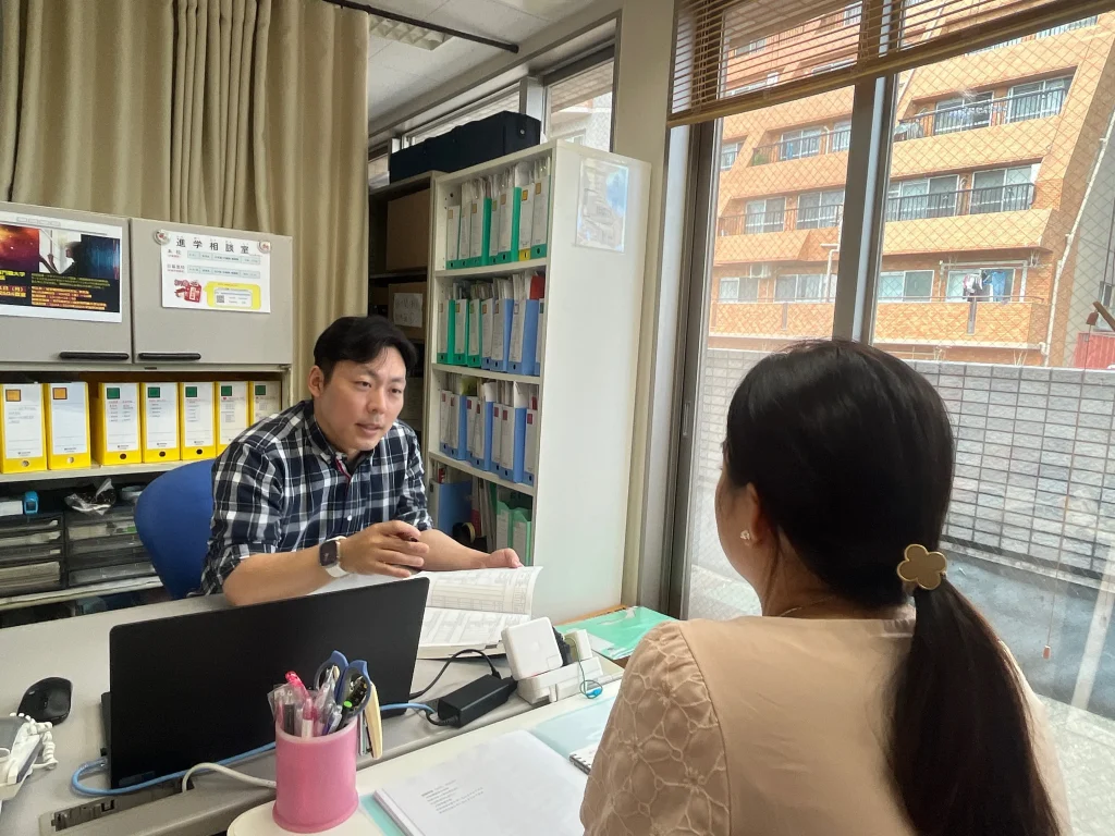 Seorang staf Akamonkai sedang memberikan konseling karier kepada siswa.